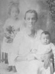 Biller as an infant with mother and sister